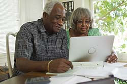 older couple reading letter about unclaimed assets